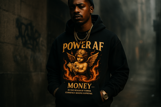 Urban fashion lifestyle photo of a model wearing a black hoodie featuring a bold graphic of a gold angelic cherub holding money, surrounded by flames. The text on the design says “Power AF” and “Money – In the realm of power, currency reigns supreme.” The hoodie is styled with dark streetwear vibes, gold jewelry, and dramatic lighting. City background with moody tones. Bold and edgy. Emphasize luxury, rebellion, and status.